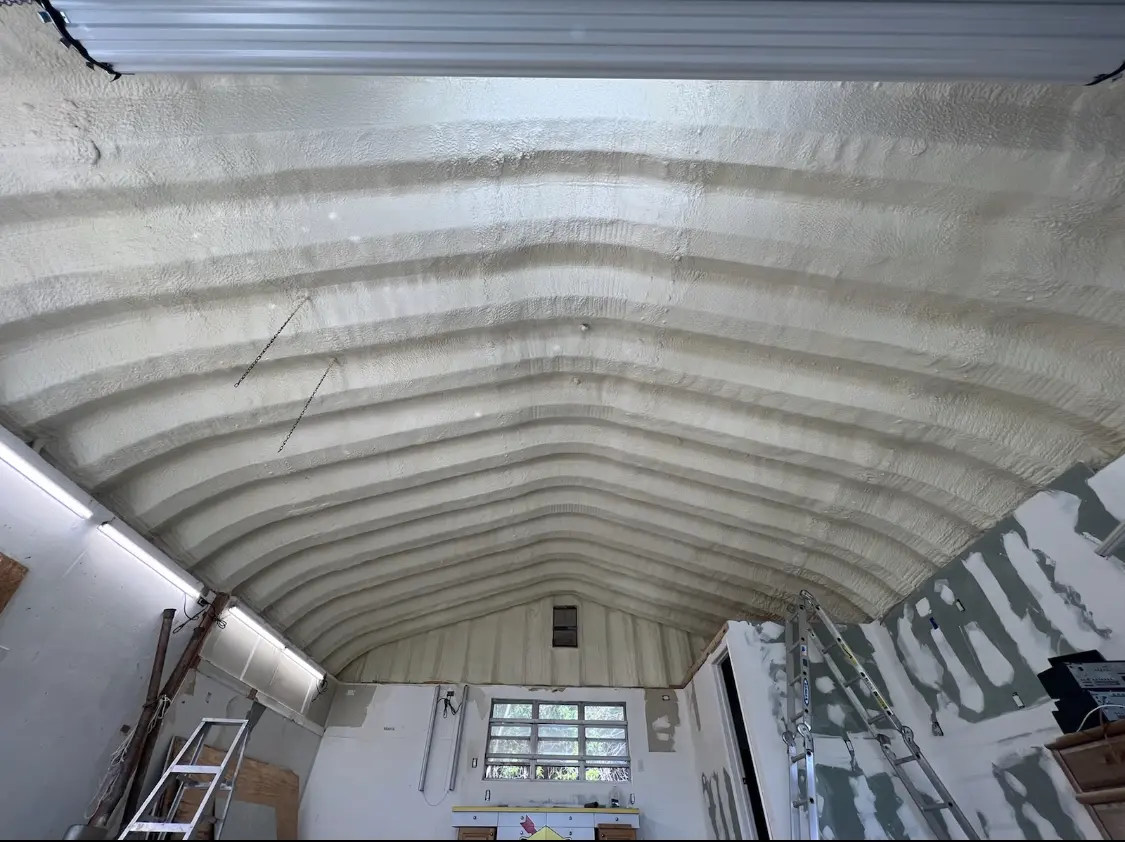 Spray polyurethane foam applied to the underside of a metal roof deck in Hampton